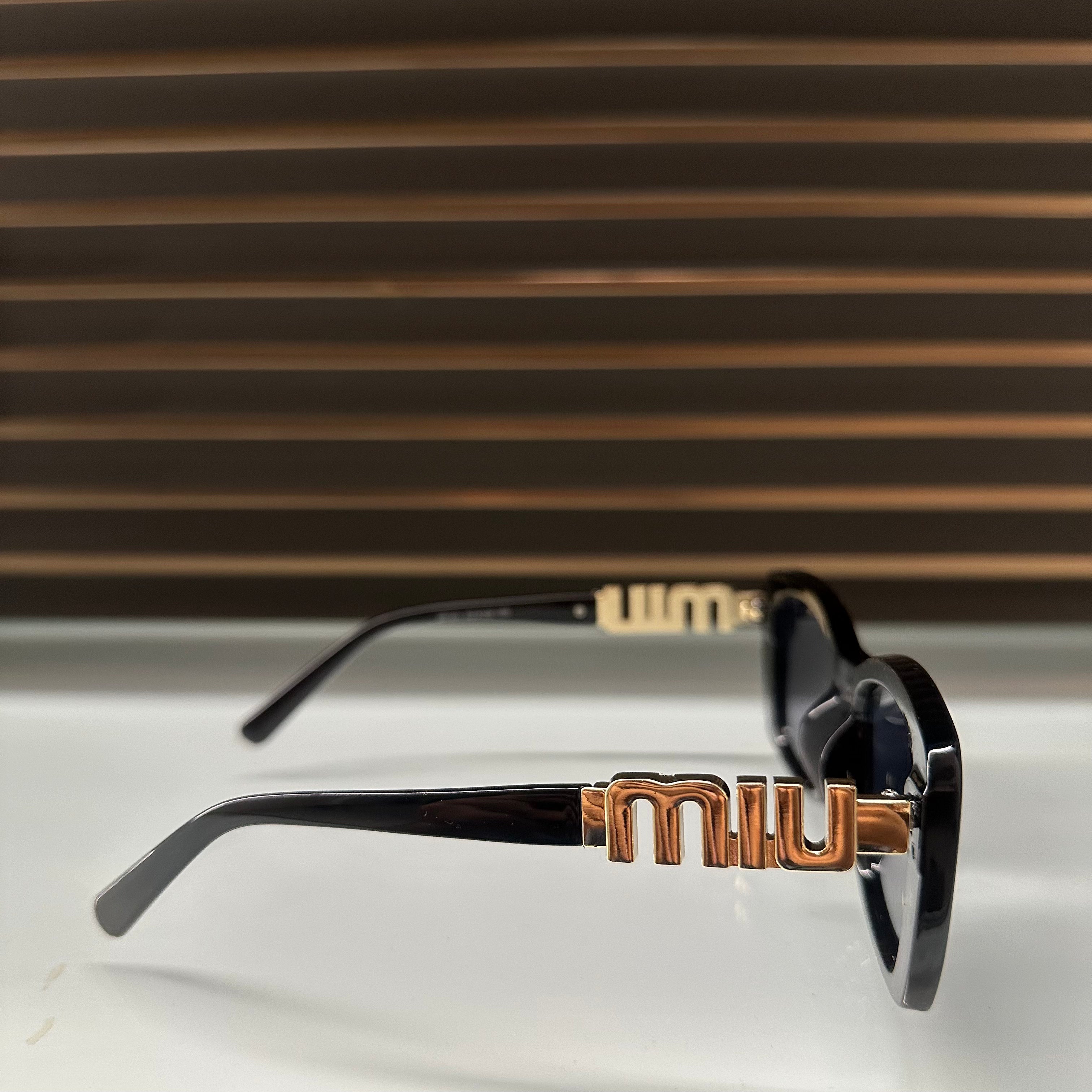 Miu Miu 26321 Sunglasses β White & Black Frames with Dark Grey or Black Lenses