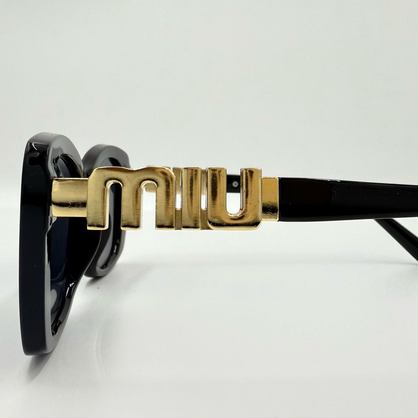 Miu Miu 26321 Sunglasses β White & Black Frames with Dark Grey or Black Lenses